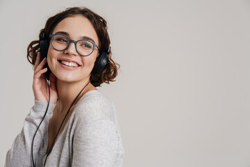 Lovely young woman listening to music with headphones