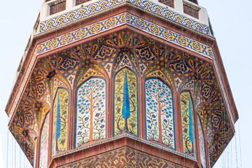 Detail of colorful kashi-kari or faience mosaic decoration on minaret of mughal era Wazir Khan mosque in the walled city of Lahore, Punjab, Pakistan