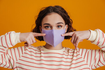 Lovely young girl in protective medical mask isolated