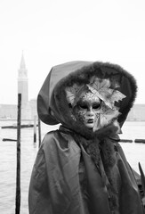 Autumn Mask in St Mark's Square square (with view on San Giorgio Maggiore island) during Carnival. Venice, Italy