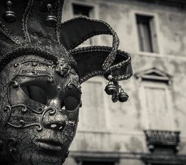 Musical mask. Venetian music carnival mask and old palazzo at background. Venice, Italy.  Black...