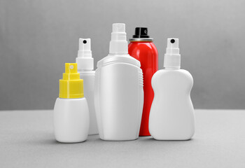 Set of different insect repellents on grey background