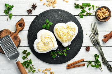 Pavlov's dessert. Bizet cakes with cream. Sweets. Top view. Rustic style.