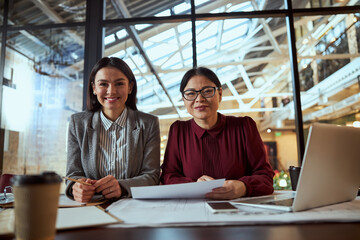 Attentive international female looking straight at camera
