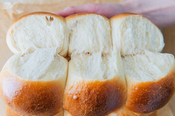 Freshly baked sourdough sweet rolls buns white wit brown crust