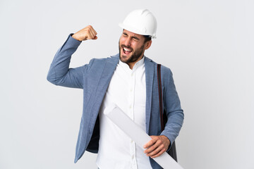 Young architect man with helmet and holding blueprints isolated on white background doing strong gesture