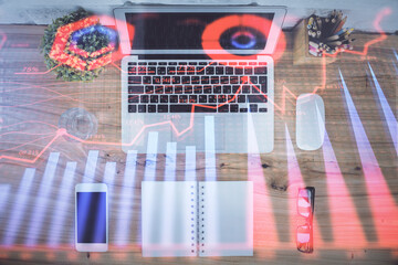 Multi exposure of financial chart drawing over table background with computer. Concept of research....