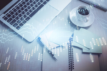 Stock market graph and top view computer on the table background. Double exposure. Concept of financial education.