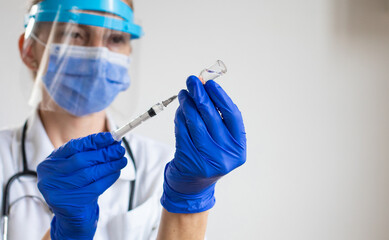 female doctor preparing to give coronavirus vaccine
