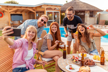 Friends taking a selfie at backyard barbecue party