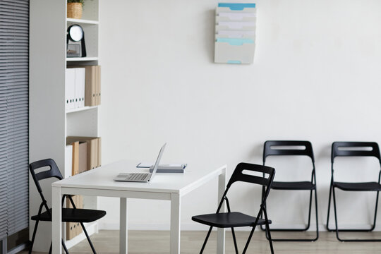 Background image of empty doctors office with desk and chairs in row, copy space