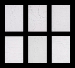 Collection of creased blank posters on black background