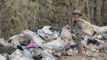  Children find junk for sale and recycle them in landfills, the lives and lifestyles of the poor, Child labor, Poverty and Environment Concepts