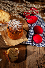 Easter cake kraffin. Kraffins with raisins, candied fruits and poppy seeds, sprinkled with powdered sugar. Close-up of homemade cake. Cruffin. Red colored eggs.