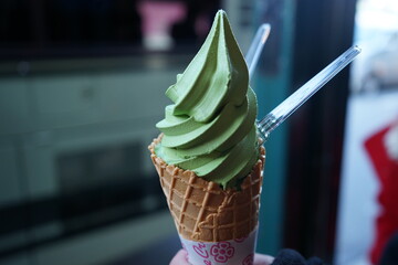 Soft Matcha Ice Cream in Waffle Cone on Street, Close Up, Decoration Creative Concept - 抹茶 ソフトクリーム 日本