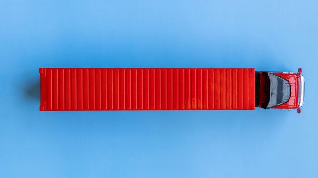 Semi trailer truck lorry container cargo vehicle on blue background, View from above, Aerial top view of semi truck with container cargo, Business logistic and transportation compay.