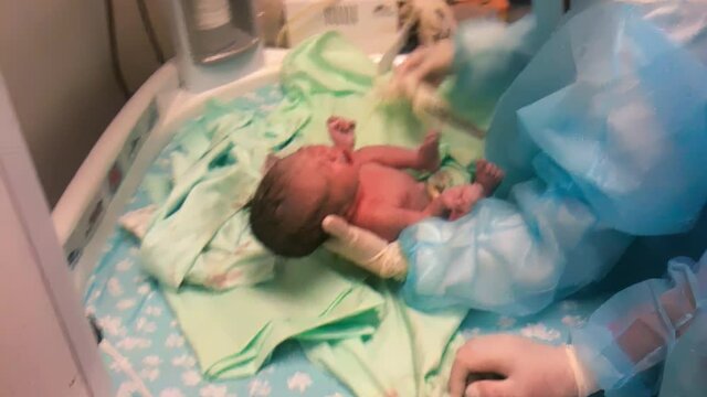 Brand New Baby.Newborn baby girl getting checked by the doctor