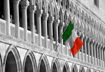 Italian flag on Doge's Palace (Ducal Palace) facade. Venice, Italy. Black white retro toned photo.