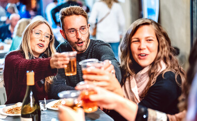 Young people having fun toasting white wine at street food festival - Happy friends eating local...