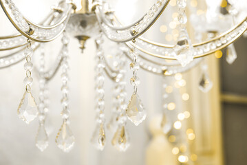 Crystal chandelier close-up. beige light. Selective focus.