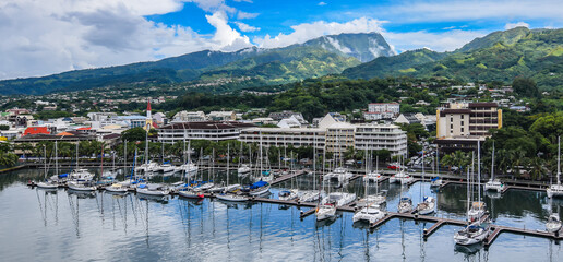 Luxury boats moored at the marina of the town Papeete, Tahiti.