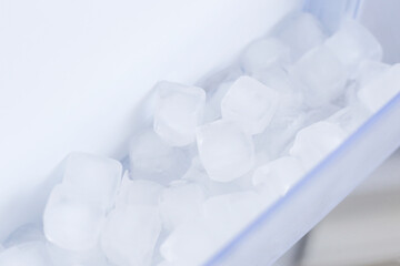 Fototapeta na wymiar Home appliance - Ice in open white refrigerator