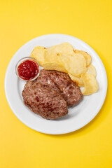 fried ground meat with tomato sauce and potato chips on dish
