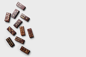 Wooden domino tiles on white background, flat lay. Space for text