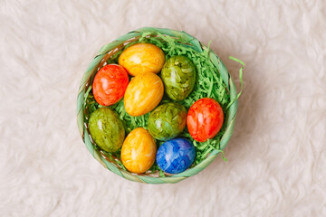 Easter card. Flat lay composition with easter eggs in a basket on white background.