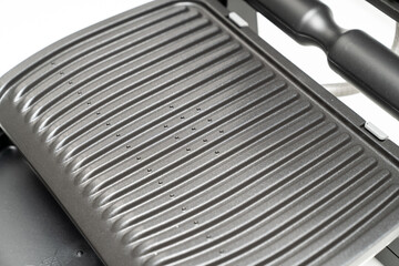 electric grill. appliance for cooking in everyday life. Made of stainless steel, special non-stick coating. healthy food. food without oil and fat. close-up