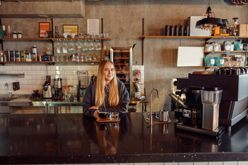 Happy smiling professional barista in cafe