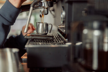 Happy smiling professional barista in cafe