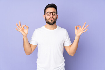 Fototapeta premium Caucasian handsome man over isolated background in zen pose