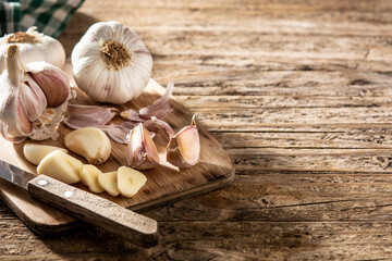 Garlic cloves on rustic wooden table.Copy space