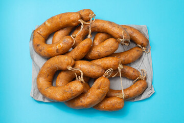 typical portuguese smoked sausages alheira on blue background