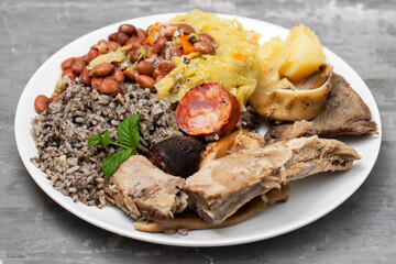 typical portuguese dish boiled meat, smoked sausages and vegetables on white dish