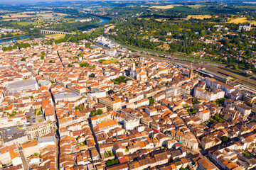 General aerial view of Agen summer cityscape on bank of Garonne river on sunny day, France