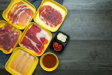 fresh raw pork, meat ,beef, belly, sliced on square plate  on wood, wooden background,set shabu, hot pot ingredients.