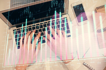 Double exposure of woman hands working on computer and forex chart hologram drawing. Top View. Financial analysis concept.