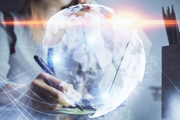 Multi exposure of woman hands typing on computer and business theme hologram drawing. Success...