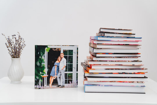 stack of books. cover photobook from photo shoot of a beautiful happy couple