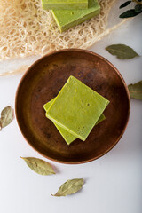 Organic natural handmade bay laurel soap with olive oil and leaves on white background. ...