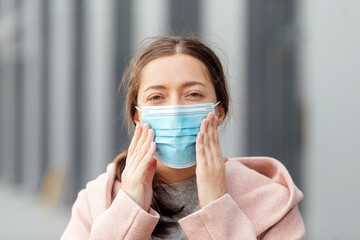 COVID-19 Pandemic Coronavirus Woman in city street wearing face mask protective for spreading of disease virus SARS-CoV-2