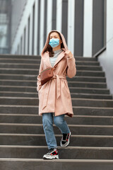 Woman wearing face protection in prevention for coronavirus outdoors