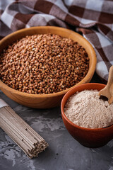 fresh natural buckwheat flour on a dark stone background culinary concept