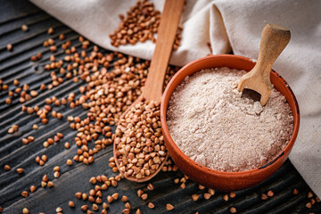 fresh natural buckwheat flour on a dark wooden rustic background culinary concept