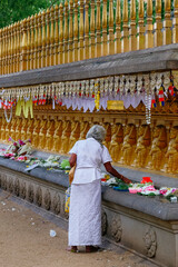 woman giving offerings in a temple