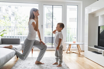 Mom with her son working out in the living room