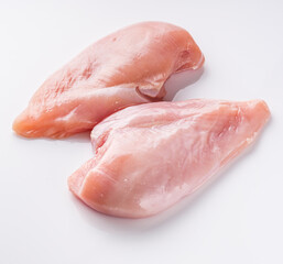 raw chicken fillet on a white acrylic background