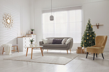 Beautiful Christmas tree and sofa in contemporary living room. Interior design